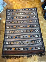 Full view of rug laid out showing overall pattern and fringe