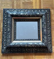 Front view of square mirror with ornate frame