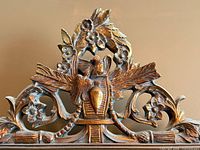 Close-up of carved crest with bird, urn, flowers
