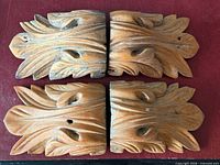 Top view of all four corbels showing carving detail and nail holes