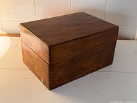 Closed wood cutlery box angled view