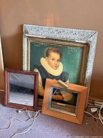 All three pieces: ornate framed print, square wood frame with light, rectangular wood mirror