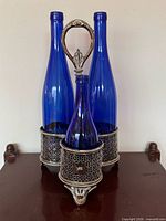 Complete tantalus stand with three cobalt bottles displayed