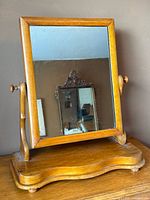 Full view of mirror facing forward on base