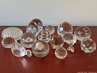 Group shot of all clear glass paperweights