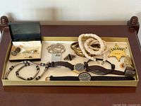 Overview of tray showing all men’s accessories