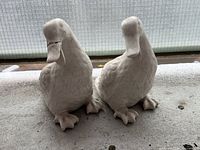 front view of both ceramic duck statues