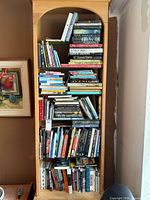 Full view of tall bookcase filled with books