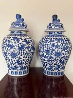 Two matching blue and white porcelain temple jars on table