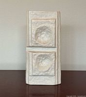 Front view of rectangular white bisque porcelain vase with two recessed circular motifs