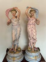 Full view of both porcelain bisque figurines on bases