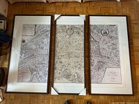 Full view of three framed map panels side by side