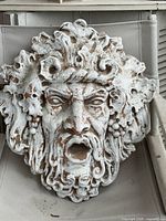 Front view of terracotta face sculpture showing full design