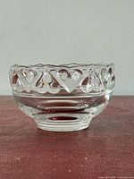 Side view showing raised heart pattern and footed base