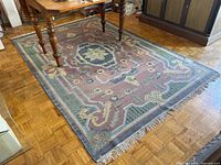 Full view of rug under table showing pattern and colors