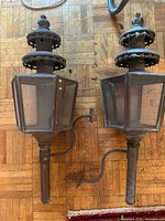 Both carriage lanterns side by side showing overall form and brackets