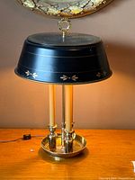 Full view of brass bouillotte lamp on table