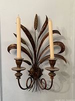 Front view of gilt wheat sheaf wall sconce showing twin candle holders and overall form