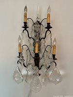 Full view of five-light metal and crystal wall sconce unplugged