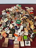 Entire pile of assorted vintage matchbooks spread out