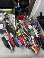 Wide view of mixed kitchen utensils spread on table