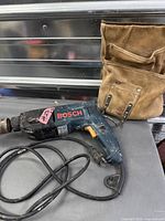 Drill and leather pouch side by side