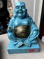 Front view of blue Laughing Buddha statue with gold belly and prayer beads