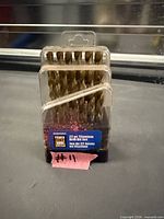 Front view of sealed 22-piece titanium drill bit set showing bits and label