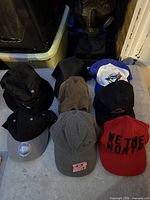 Eight assorted baseball caps laid out in two rows