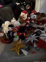 Overall lot with plush figures, star toppers and lights visible