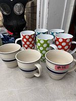 Group view of three stripe mugs and four polka-dot tall mugs