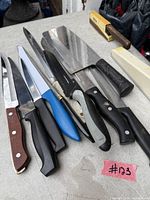 All knives and cleaver laid out on table