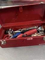 Red Mastercraft toolbox open showing assortment of hand tools