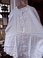 Front view of striped shirt on hanger