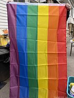 Full view of six-stripe rainbow pride flag held upright
