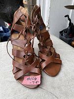 Front view of brown strappy lace-up sandals