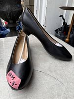 Pair of black pumps side view showing uppers and toe profile