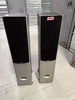 Full view of both Quest tower speakers standing side by side