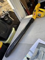 Full view of yellow Paramount leaf blower with black nozzle on table