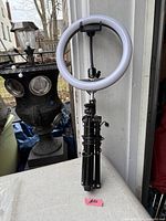 Full view of ring light mounted on folded tripod stand