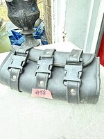 Front view showing three buckle straps and rivets