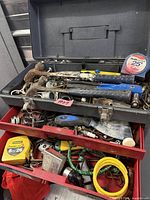 Open toolbox and drawers showing variety of tools and hardware