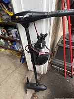 Full view of Minn Kota trolling motor with shaft, propeller, mounting bracket and wiring visible