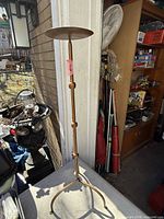 Full view of gilded iron candle stand