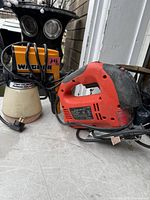 Wagner paint sprayer and red jigsaw on table