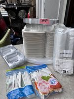All items together showing white compartment containers, clear containers, cups sleeve, cutlery bag, straws bag