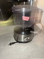 Front view of Hamilton Beach food processor with stainless base and clear bowl