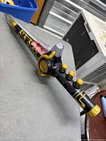 Overall view of Hasbro Dragon Dagger showing blade, hilt buttons and colour scheme