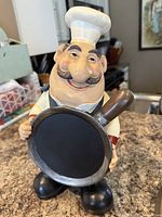 Front view of chef figurine with pan