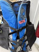 Front view showing blue panels, straps, and Fluid logo